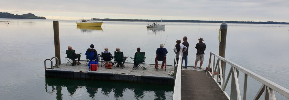 Hetherington House residents fishing off of a dock.