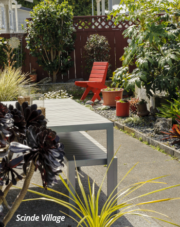 The Napier District Masonic Trust Scinde Village outdoor area with a bench, table, plants.