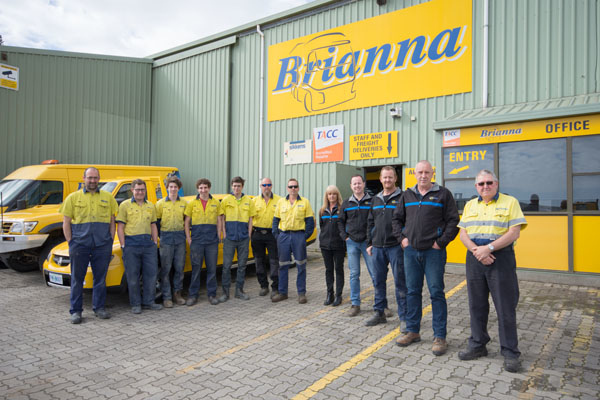 Brianna Tilt Trays & Towing Pty Ltd. group photo of employees outside their building.