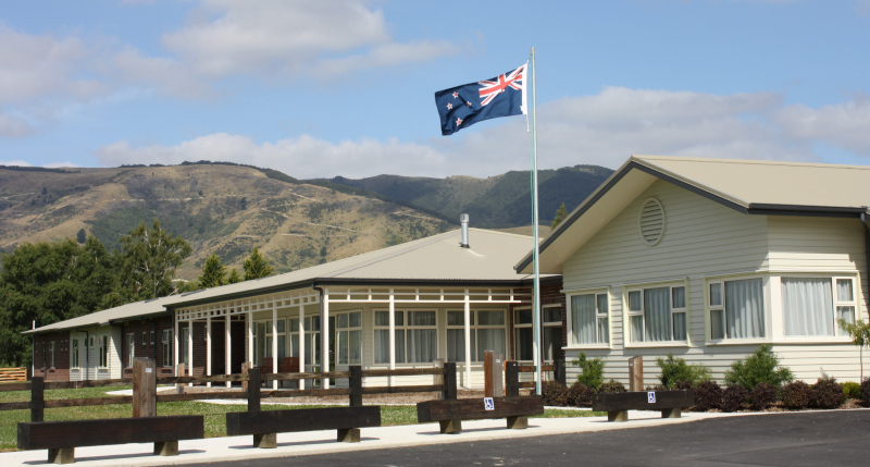 West Otago Health Ltd. exterior with flag.