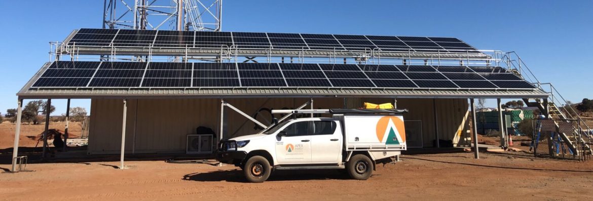 Apex Energy Australia solar panel with work vehicle in front.