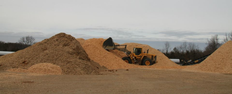 azwood energy piles of wood with a loader